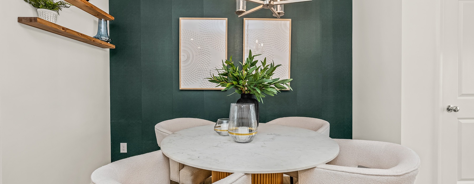 table with seating with a green wall 